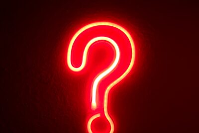 Photo of a red, neon question mark against a black wall. Photo of a red, glowing, neon heart against a wall. Photo by Alina Rubo on Unsplash