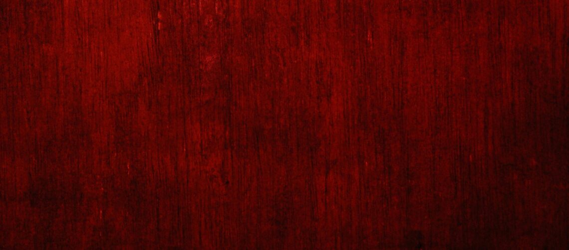 Background photo of a red tapestry with a gradient of colors from red to black. Photo by Bangsal Nam on Unsplash
